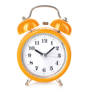 Retro alarm clock close-up isolated on a white background.